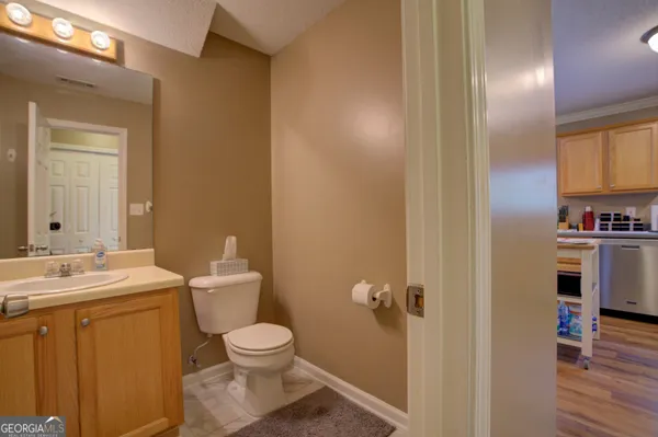 a bathroom with a toilet a sink and mirror