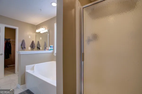 a bathroom with a bathtub and shower