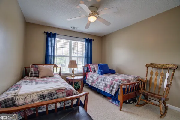 a bedroom with a bed and a table in it