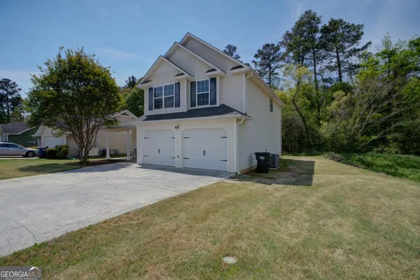 a house that has a tree in front of it