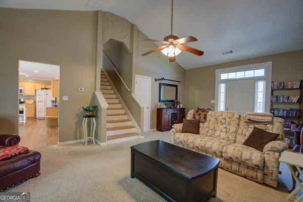 a living room with furniture and wooden floor