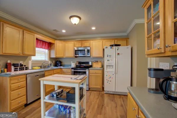 a kitchen with stainless steel appliances granite countertop a refrigerator stove microwave and sink