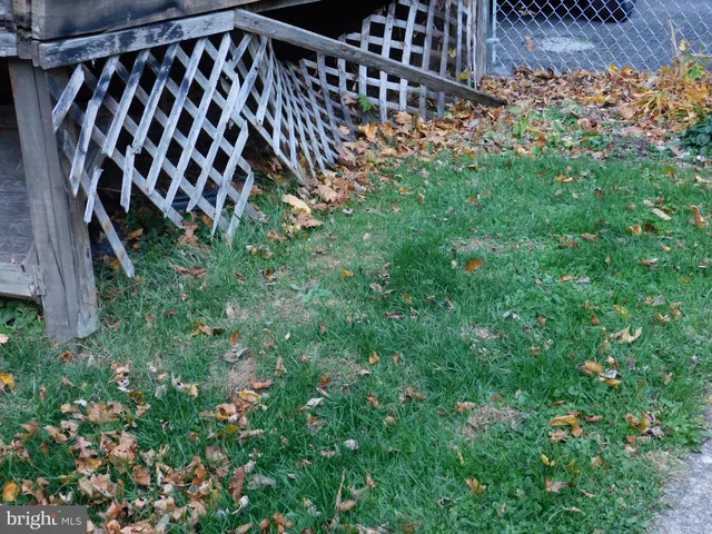 a view of a brick house with a small yard
