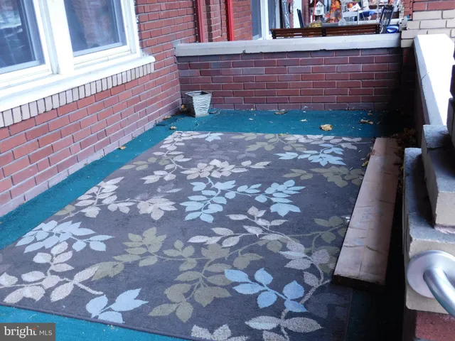 a view of a brick house with large windows
