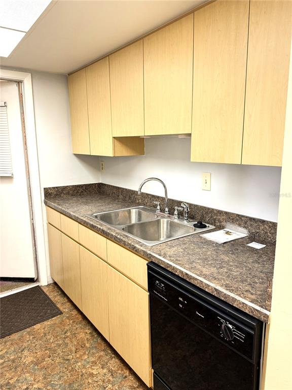 12760 Indian Rocks Road, Unit 562 Largo, FL 33774 - Photo 8 of 22 a kitchen with granite countertop a sink a stove and cabinets