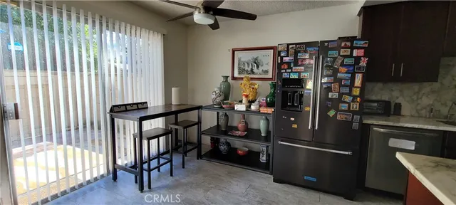a kitchen with appliances cabinets and a table