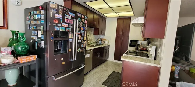 a kitchen with stainless steel appliances kitchen island granite countertop a refrigerator a stove and a microwave