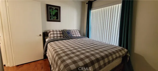 a bedroom with a bed and a window