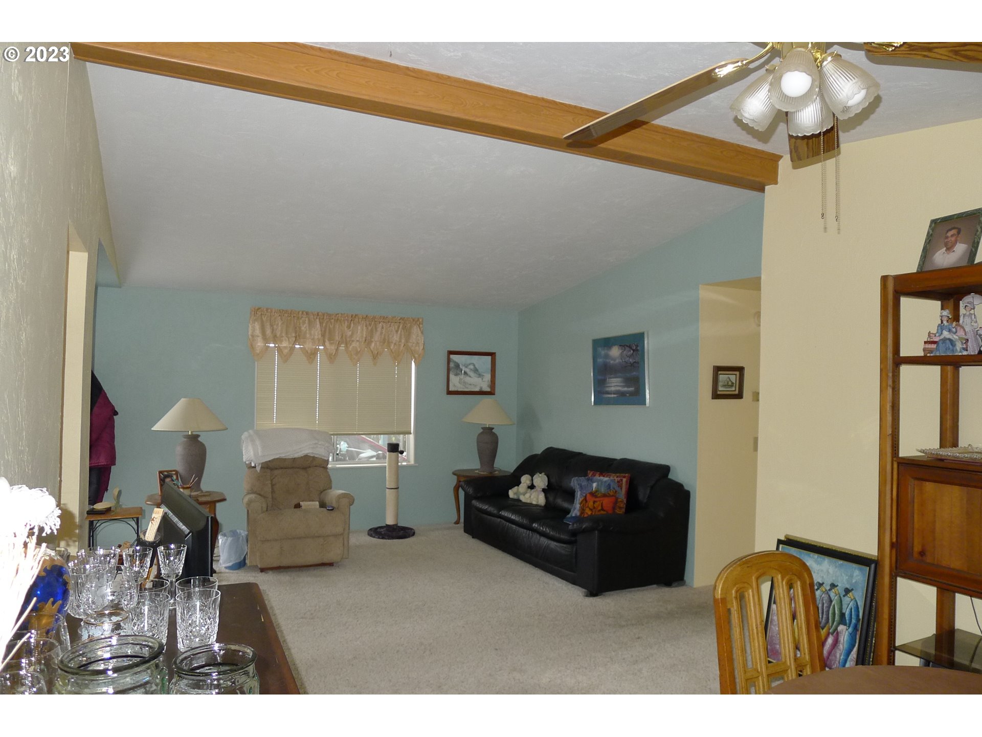 100 River Bend Road, Unit 117 Reedsport, OR 97467 - Photo 8 of 35 a bedroom with furniture and a chandelier