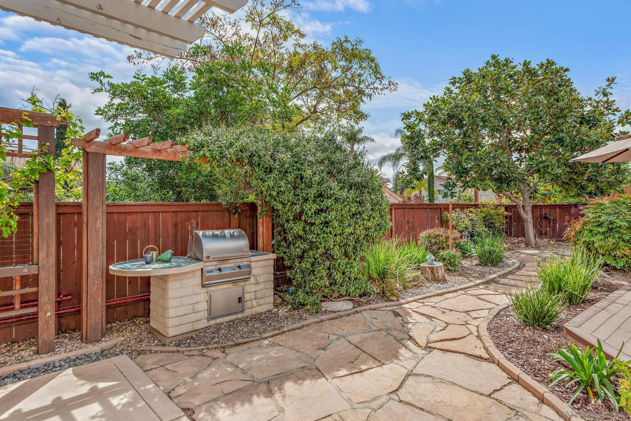 111 Wintercreek Place Santee, CA 92071 - Photo 12 of 53 a chair and table in a backyard of the house