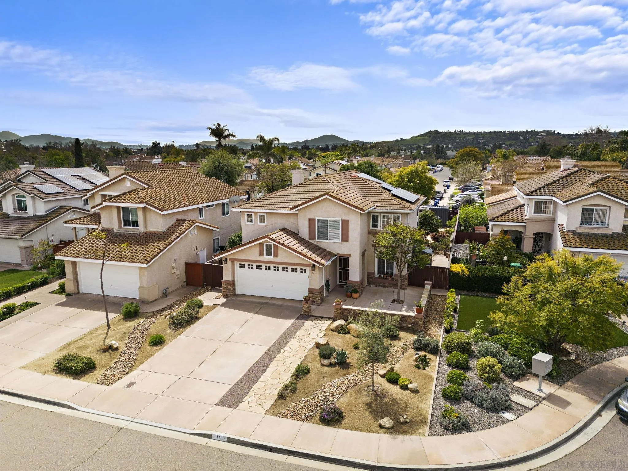 111 Wintercreek Place Santee, CA 92071 - Photo 49 of 53 a view of a white house with a yard and potted plants