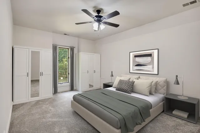a bedroom with a large bed and a chandelier