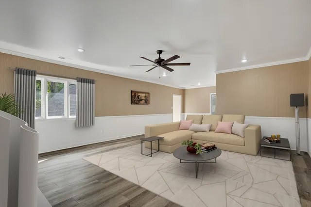 a living room with furniture a window and a ceiling fan