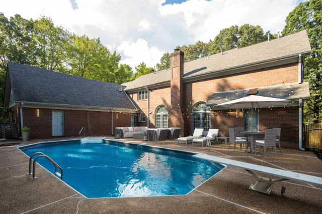a view of a patio with chairs and a table