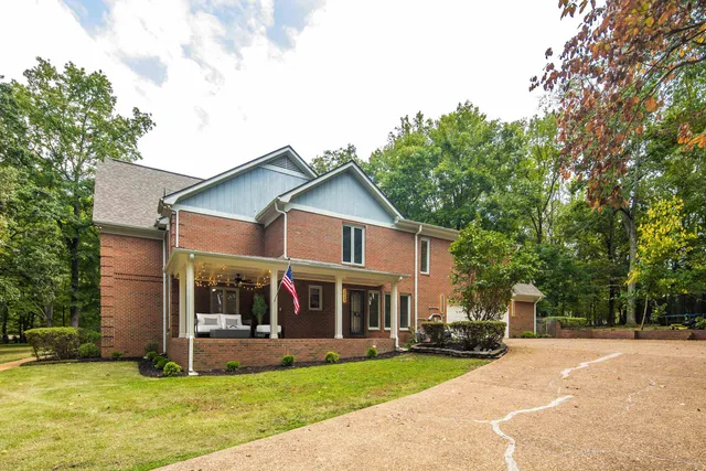 a view of a house with a yard patio and a garden