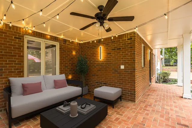 a view of a patio with couches and potted plants