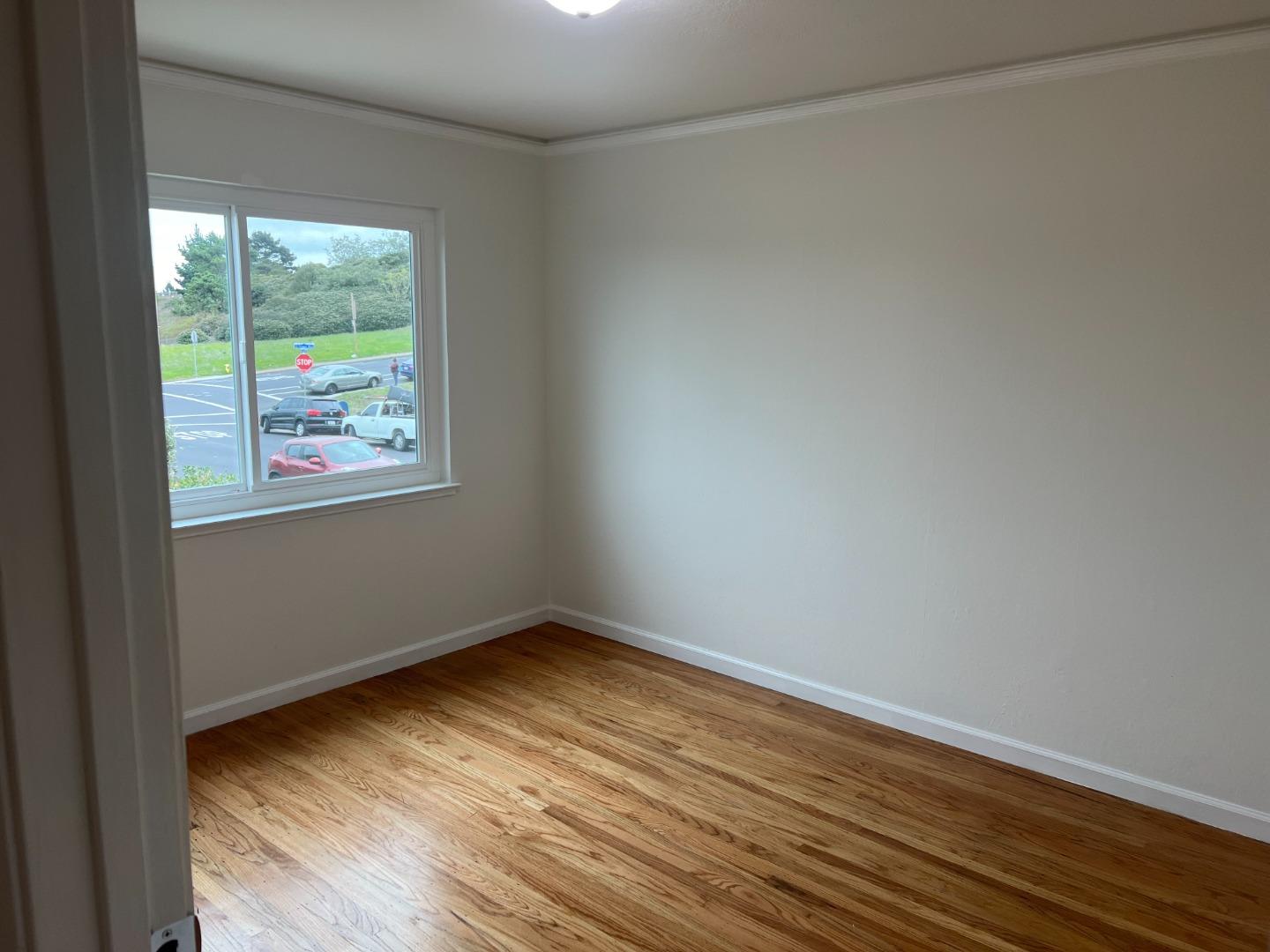 99 Castillejo Drive Daly City, CA 94015 - Photo 11 of 21 a view of an empty room with wooden floor and a window
