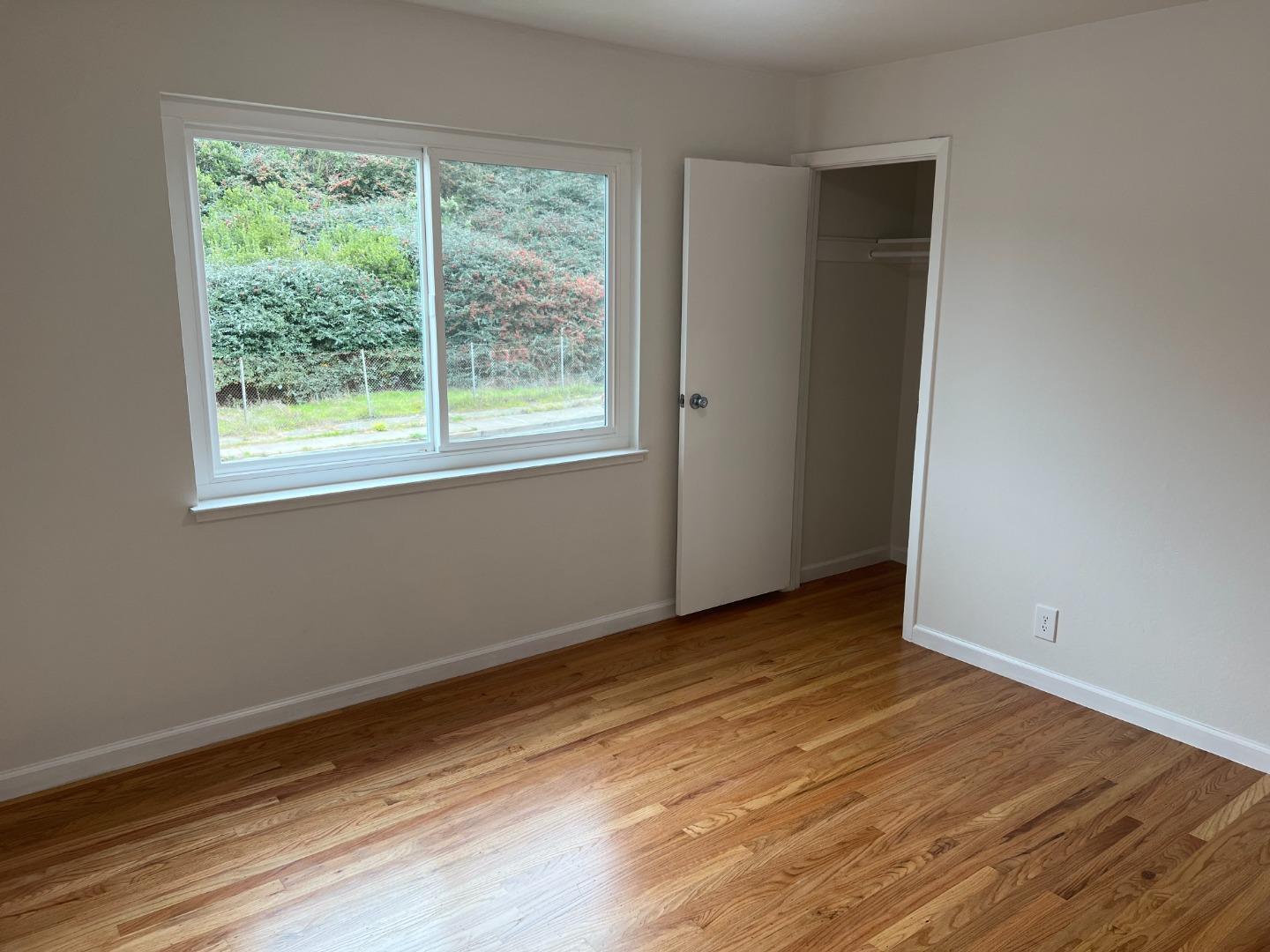 99 Castillejo Drive Daly City, CA 94015 - Photo 12 of 21 a view of an empty room with wooden floor and a window