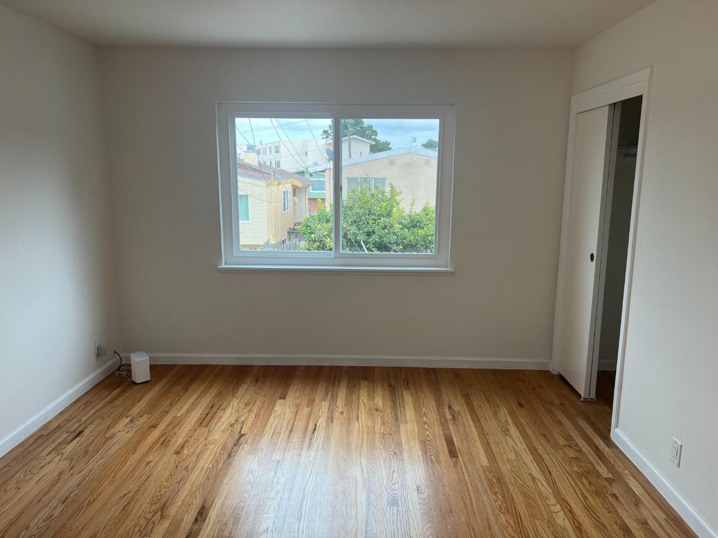 99 Castillejo Drive Daly City, CA 94015 - Photo 10 of 21 an empty room with wooden floor and windows