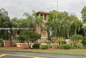 a front view of a house with a yard and lake view