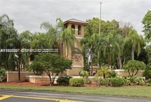 a front view of a house with a yard and lake view