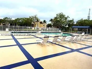 a view of a swimming pool with a lawn chairs