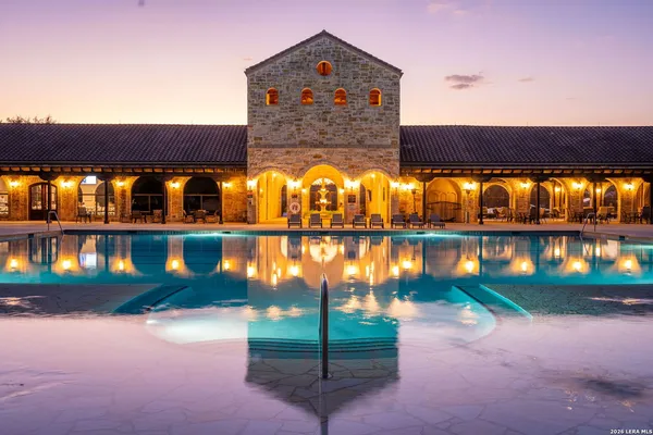 an aerial view of residential houses with outdoor space and parking