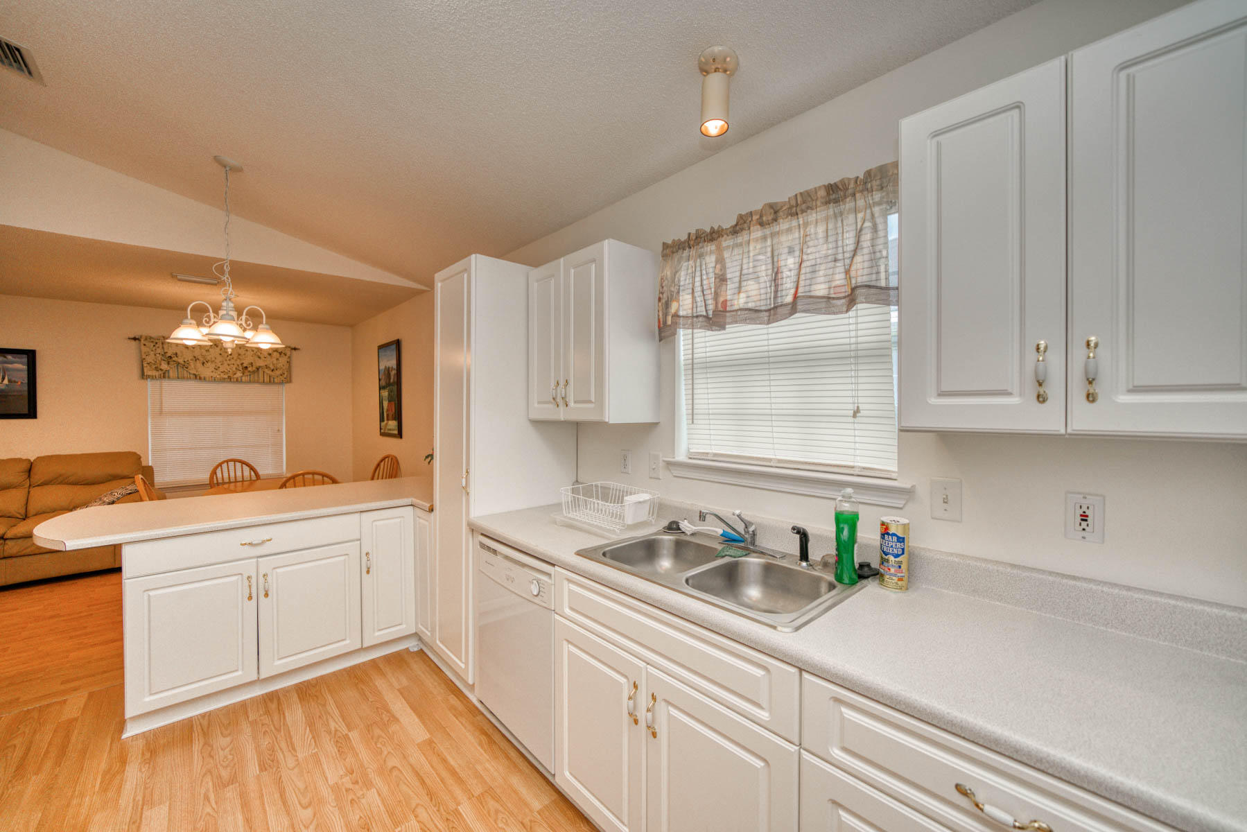 1755 Old Ranch Road Fort Walton Beach, FL 32547 - Photo 11 of 35 a kitchen with kitchen island white cabinets and white appliances