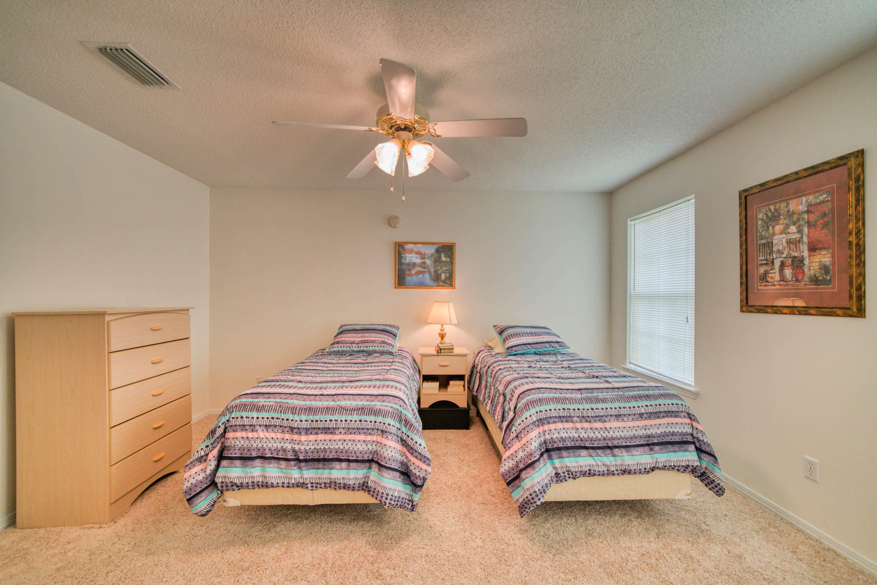 1755 Old Ranch Road Fort Walton Beach, FL 32547 - Photo 18 of 35 a bedroom with two beds and a chandelier