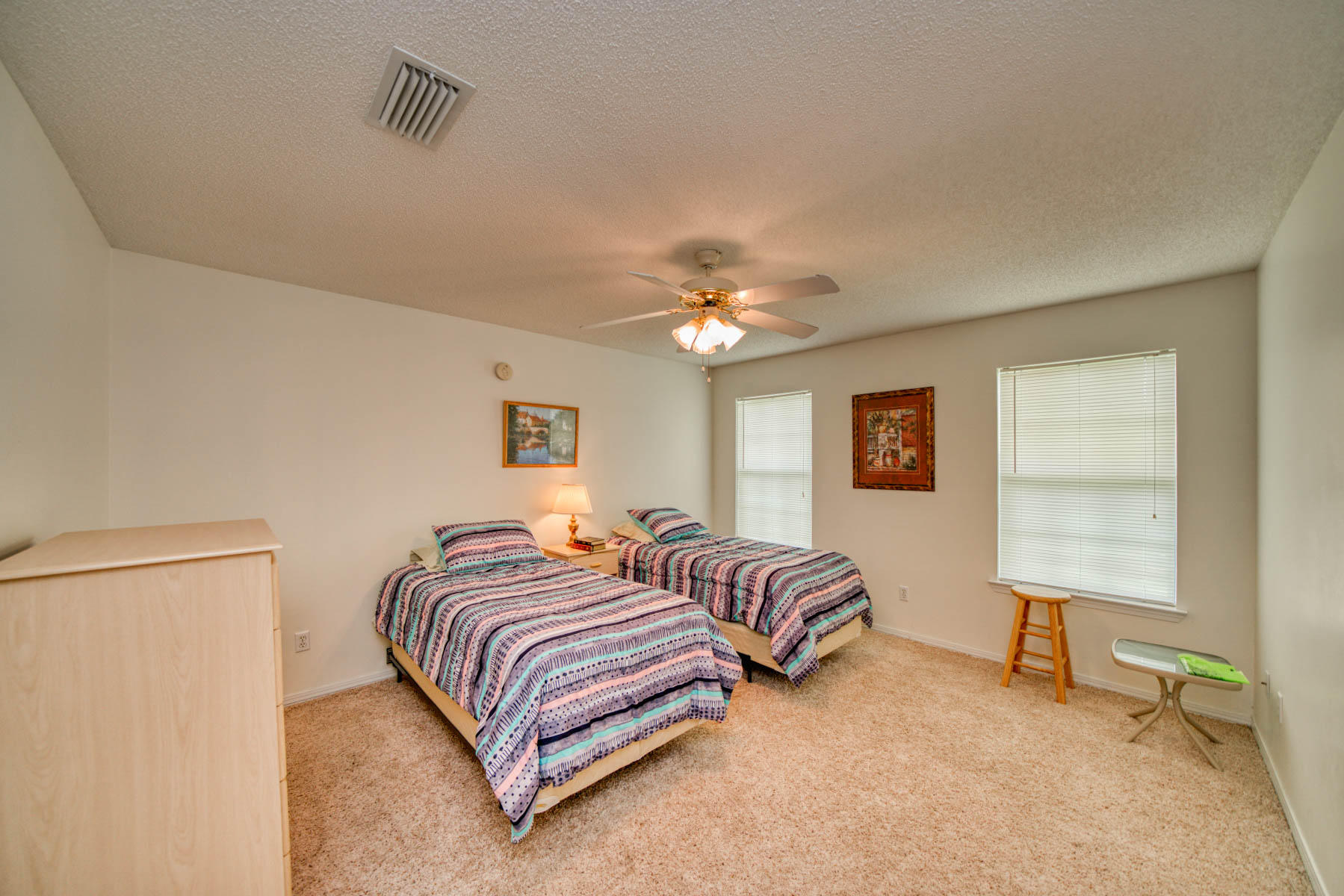 1755 Old Ranch Road Fort Walton Beach, FL 32547 - Photo 19 of 35 a spacious bedroom with a bed and a table in it