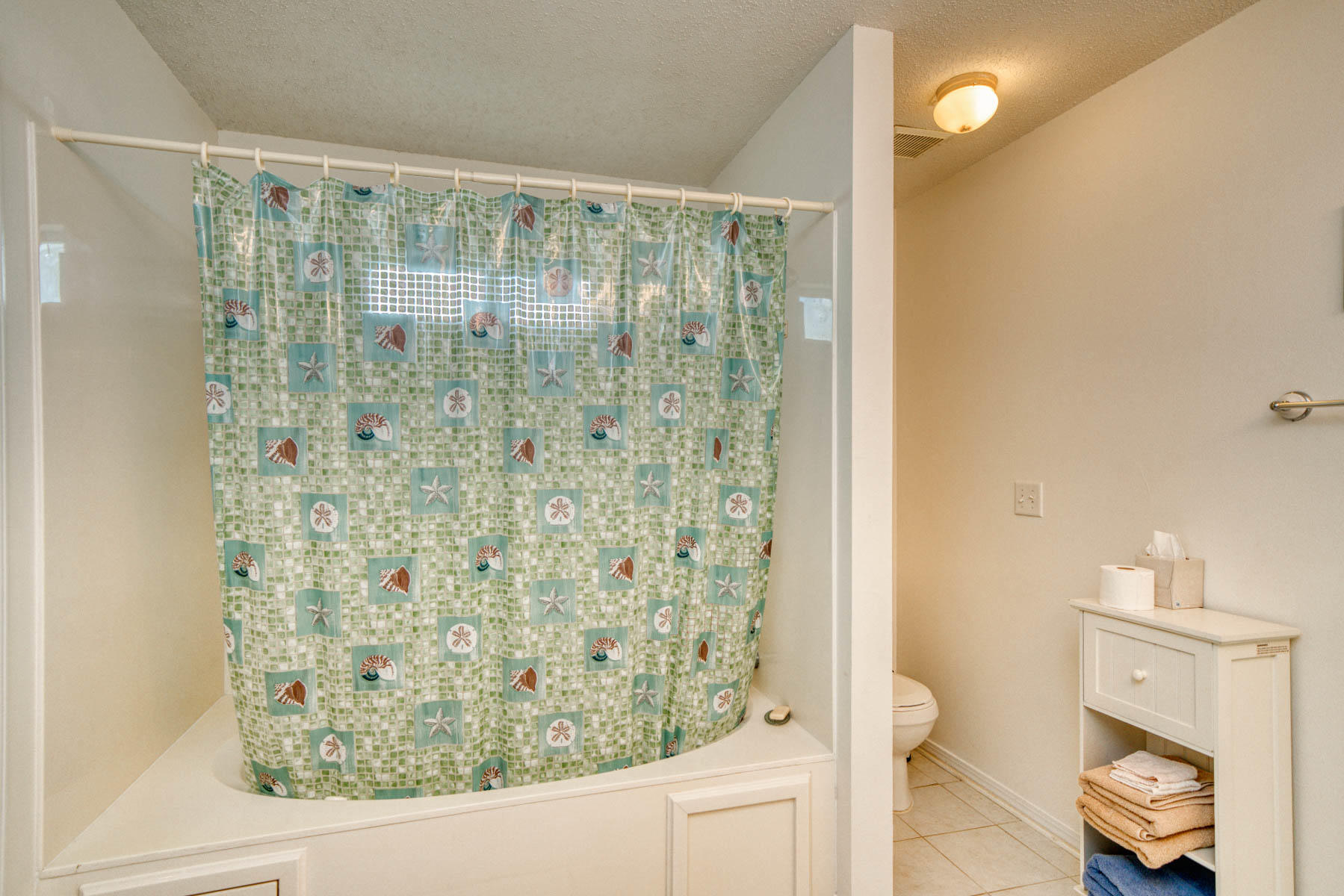 1755 Old Ranch Road Fort Walton Beach, FL 32547 - Photo 21 of 35 a bathroom with a shower curtain and a toilet