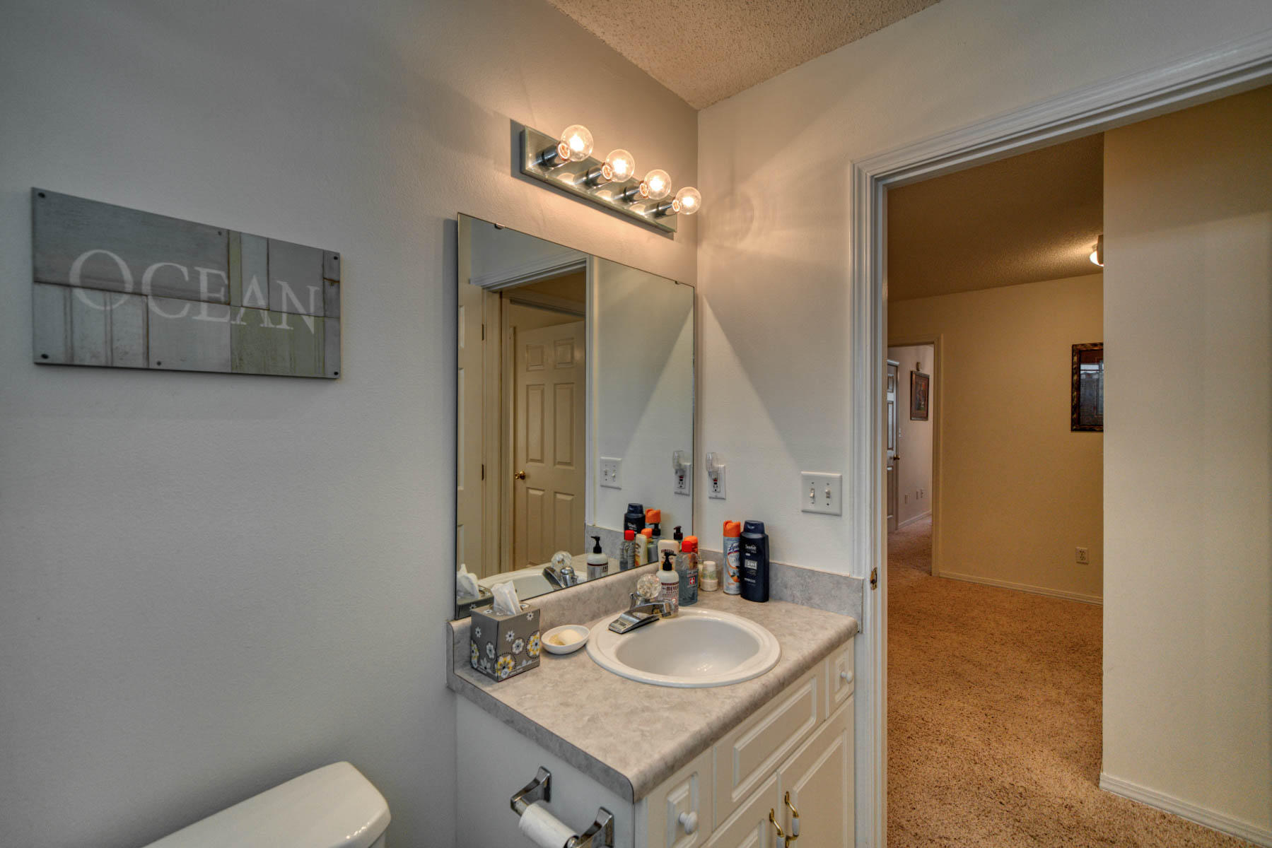 1755 Old Ranch Road Fort Walton Beach, FL 32547 - Photo 27 of 35 a bathroom with a granite countertop sink and a mirror