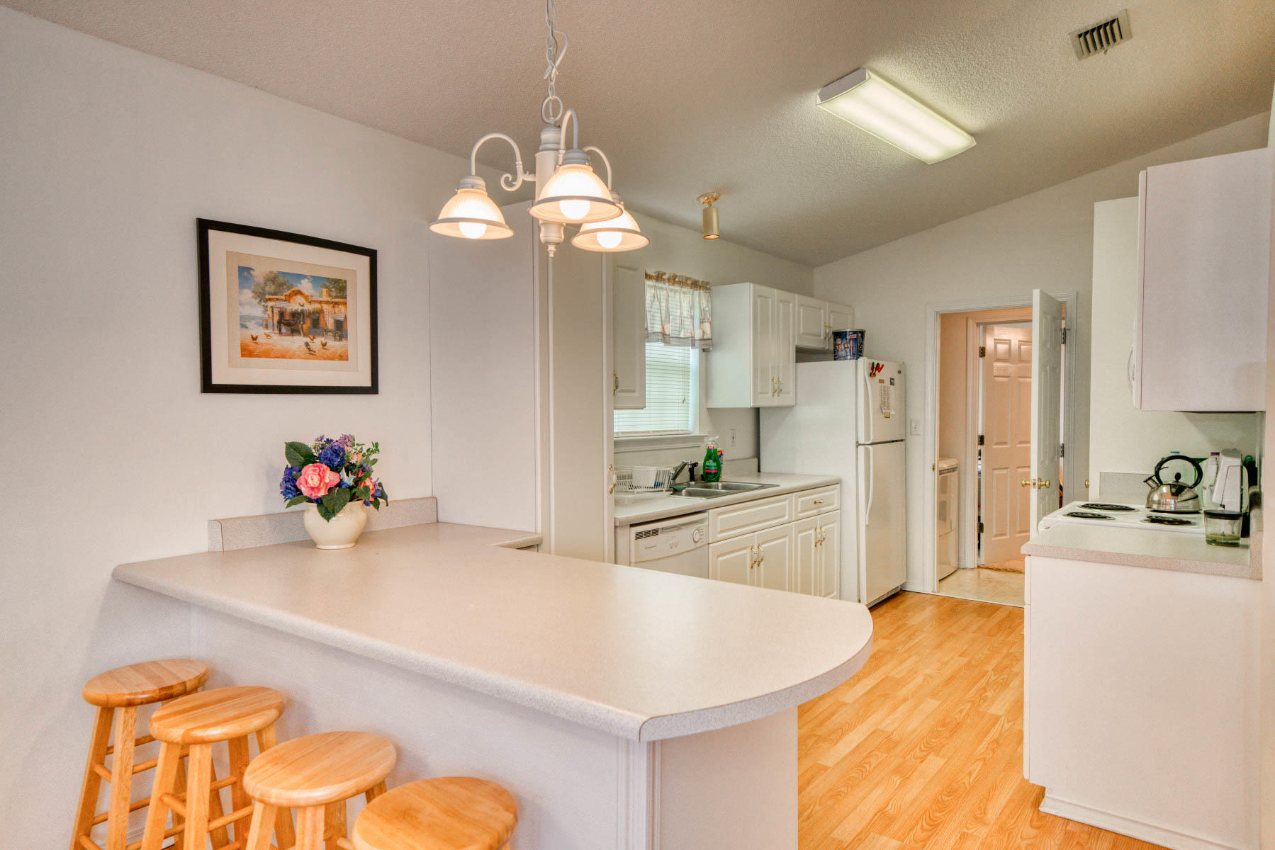 1755 Old Ranch Road Fort Walton Beach, FL 32547 - Photo 8 of 35 a kitchen with kitchen island a stove a sink and a refrigerator