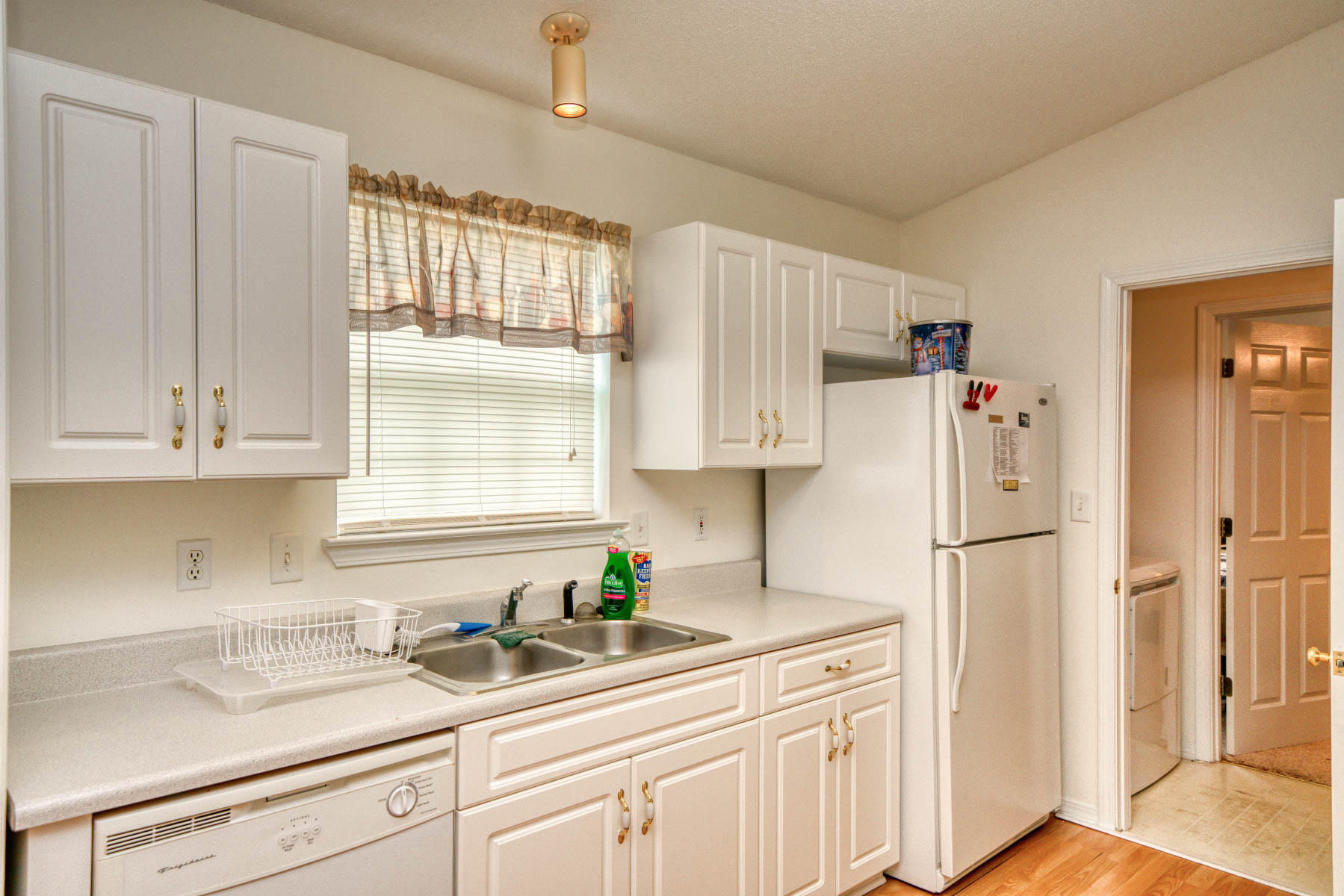 1755 Old Ranch Road Fort Walton Beach, FL 32547 - Photo 9 of 35 a kitchen with granite countertop a refrigerator a sink and white cabinets