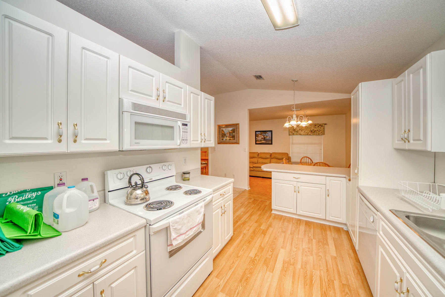 1755 Old Ranch Road Fort Walton Beach, FL 32547 - Photo 10 of 35 a kitchen that has a lot of white cabinets and wooden floor