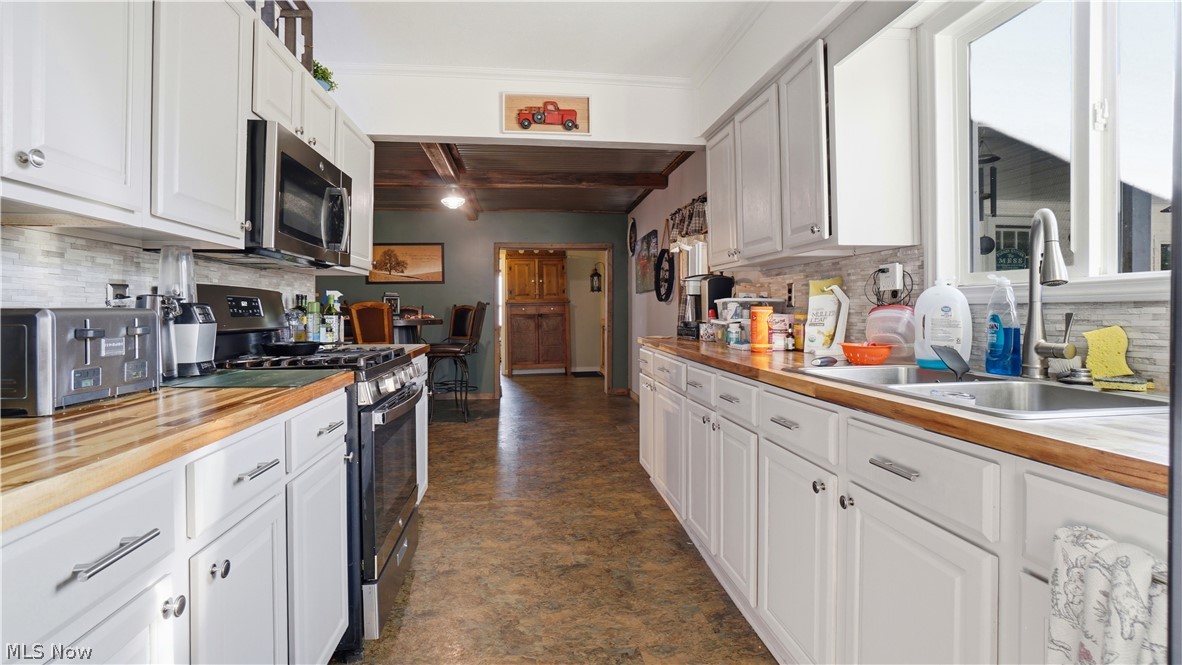 65892 Endley Road Cambridge, OH 43725 - Photo 23 of 50 Kitchen with tasteful backsplash and white cabinetry