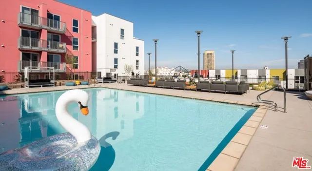 a swimming pool with outdoor seating and yard