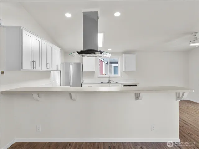 a kitchen with stainless steel appliances a sink a stove and cabinets