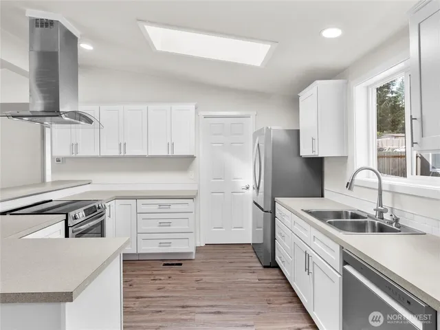 a kitchen with stainless steel appliances granite countertop a sink stove and refrigerator