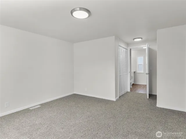 a view of an empty room and a bathroom