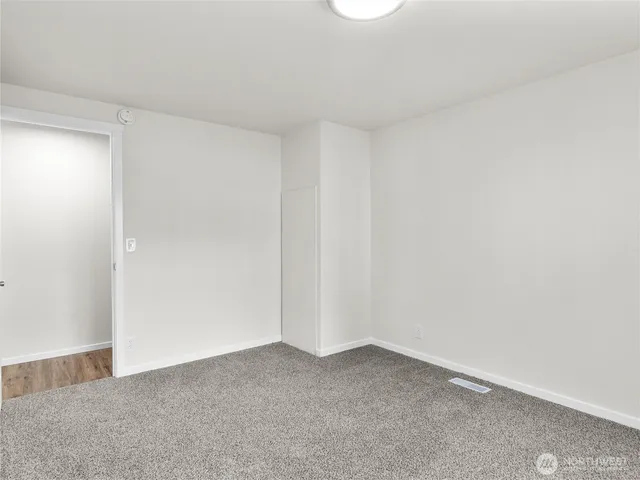 a bedroom with a large bed and chandelier