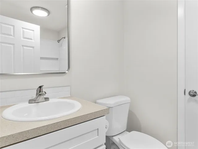a white toilet sitting next to a bath tub
