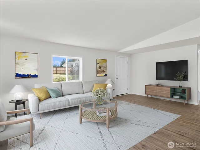a living room with furniture and a flat screen tv
