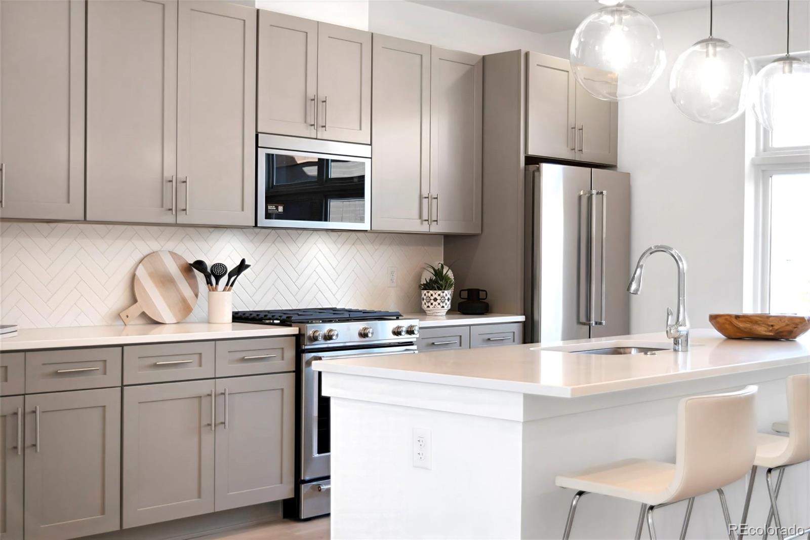 22 Oneida Court Denver, CO 80230 - Photo 2 of 44 a kitchen with white cabinets and stainless steel appliances