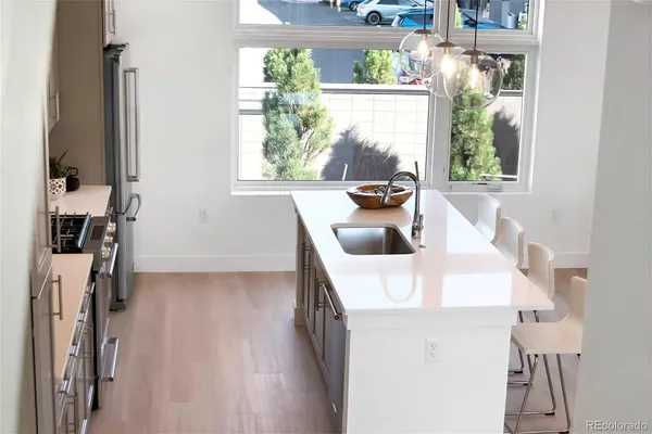 a kitchen with stainless steel appliances white cabinets and a stove