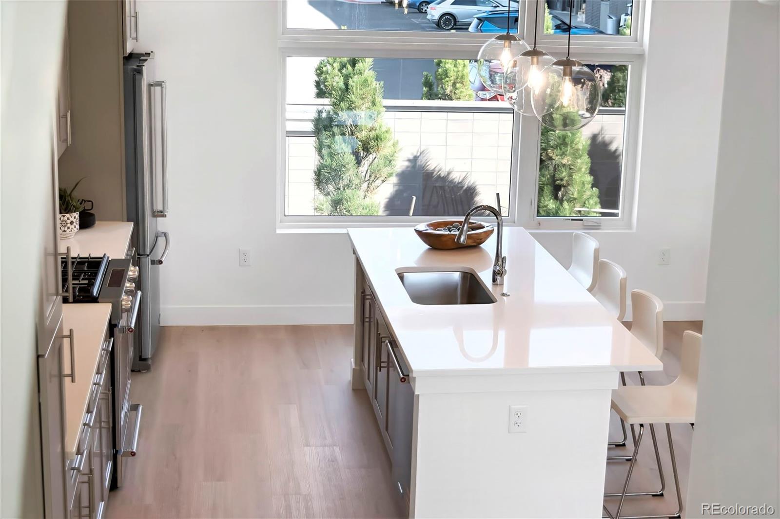 22 Oneida Court Denver, CO 80230 - Photo 22 of 44 a kitchen with a sink a counter top space and a window