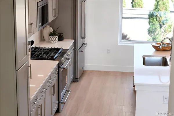 a kitchen with a sink a counter and chairs