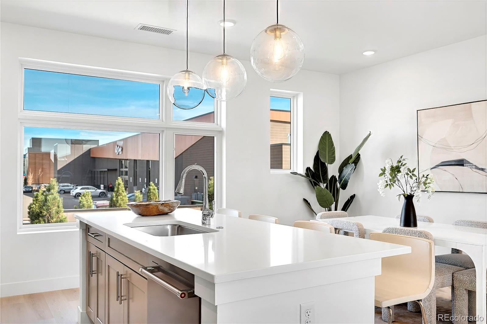 22 Oneida Court Denver, CO 80230 - Photo 28 of 44 a kitchen with a sink a counter and chairs
