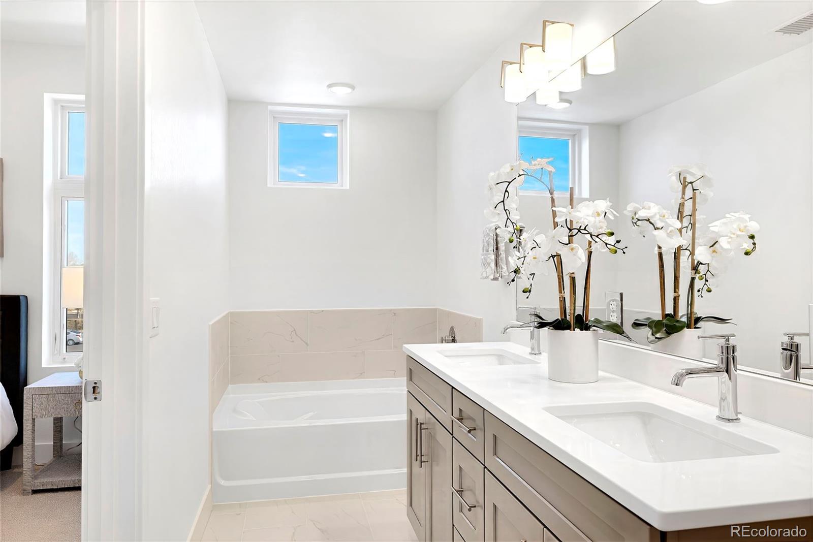 22 Oneida Court Denver, CO 80230 - Photo 36 of 44 a bathroom with a tub sink and mirror