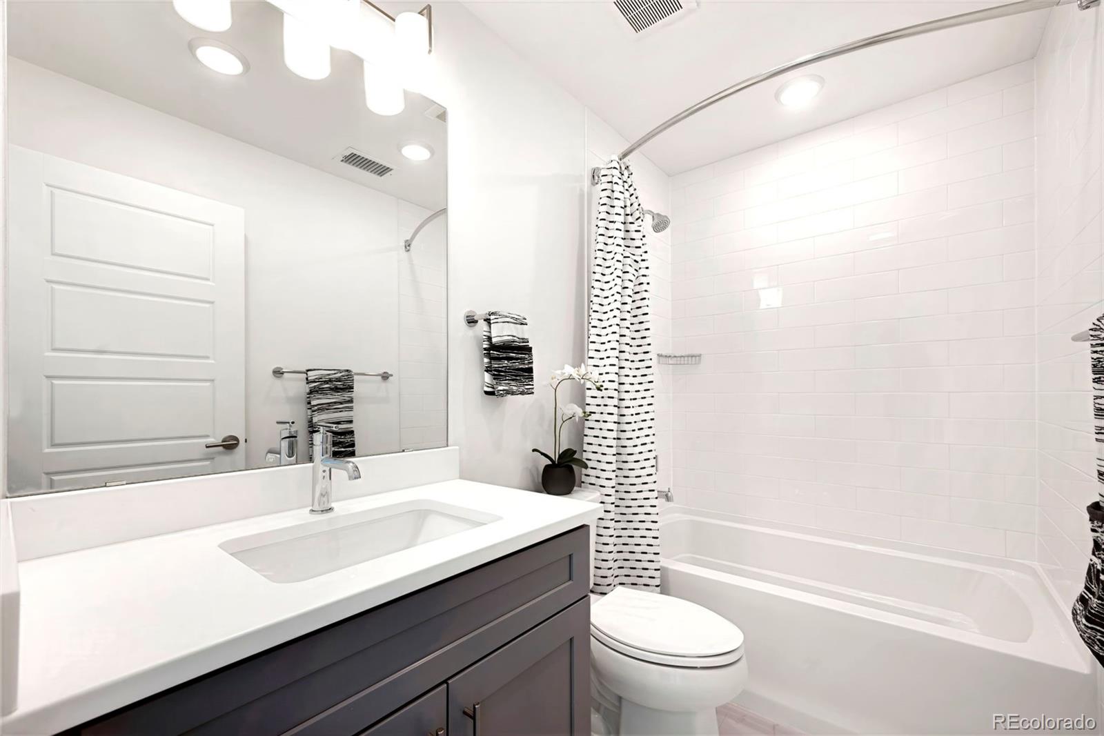 22 Oneida Court Denver, CO 80230 - Photo 41 of 44 a bathroom with a sink a toilet and shower